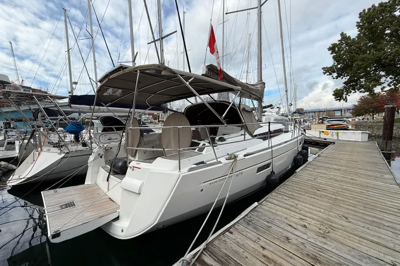 Shaboom Yacht Photos Pics 2017 Jeanneau Sun Odyssey 479 sailboat docked at marina under cloudy sky.