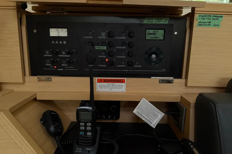 Shaboom Yacht Photos Pics Control panel of 2017 Jeanneau Sun Odyssey 479 sailboat with communication equipment.