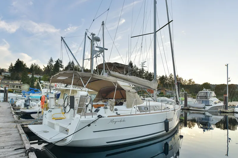 Mayne Deck Yacht Photos Pics 2019 Dufour 382 Grand Large sailboat docked at a marina, surrounded by other boats.