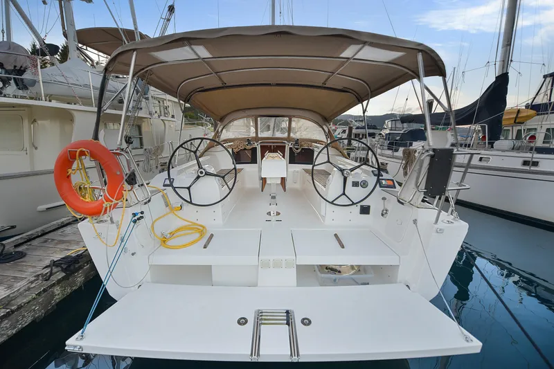 Mayne Deck Yacht Photos Pics 2019 Dufour 382 Grand Large sailboat docked, featuring dual steering wheels and spacious cockpit.