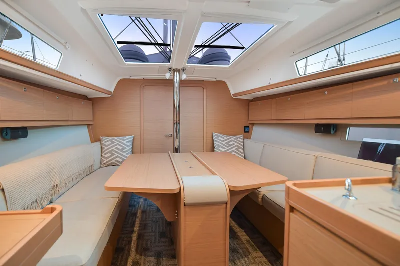 Mayne Deck Yacht Photos Pics Interior of 2019 Dufour 382 Grand Large yacht with modern wood finish and seating area.