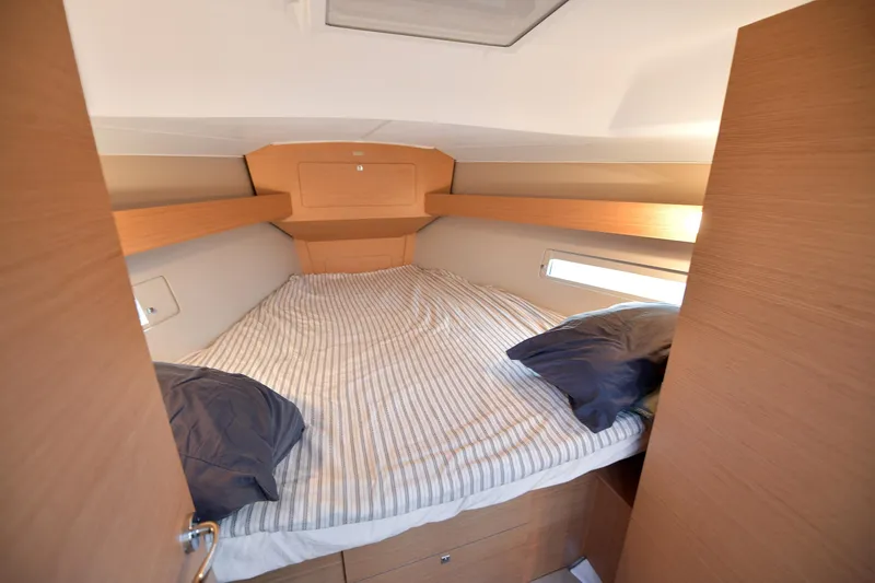 Mayne Deck Yacht Photos Pics Cozy cabin interior of 2019 Dufour 382 Grand Large yacht with striped bedding.