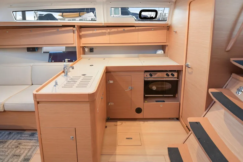 Mayne Deck Yacht Photos Pics Interior of 2019 Dufour 382 Grand Large yacht, featuring modern kitchen and seating area.