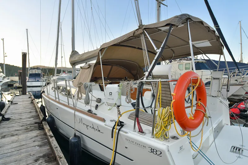 Mayne Deck Yacht Photos Pics 2019 Dufour 382 Grand Large sailboat docked with lifebuoy and canopy.