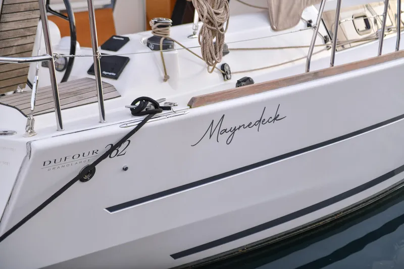 Mayne Deck Yacht Photos Pics 2019 Dufour 382 Grand Large sailboat docked, featuring sleek design and "Maynedeck" name.