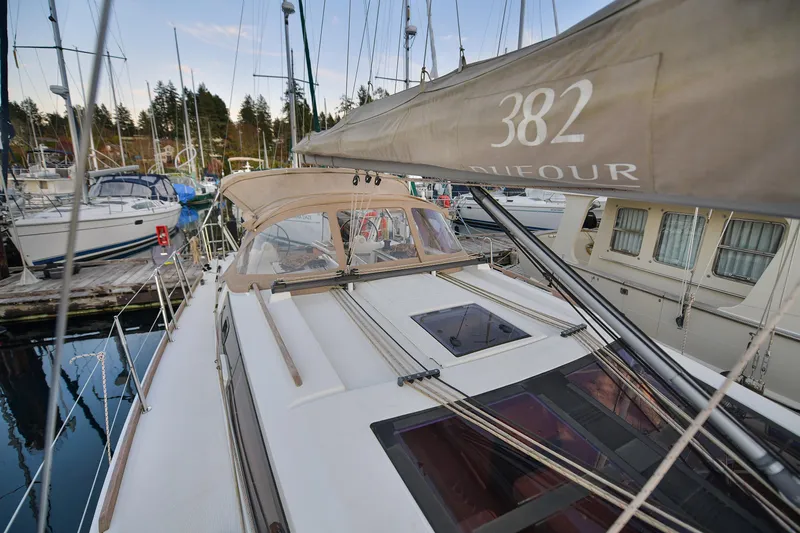 Mayne Deck Yacht Photos Pics 2019 Dufour 382 Grand Large sailboat docked at marina, showcasing deck and rigging.