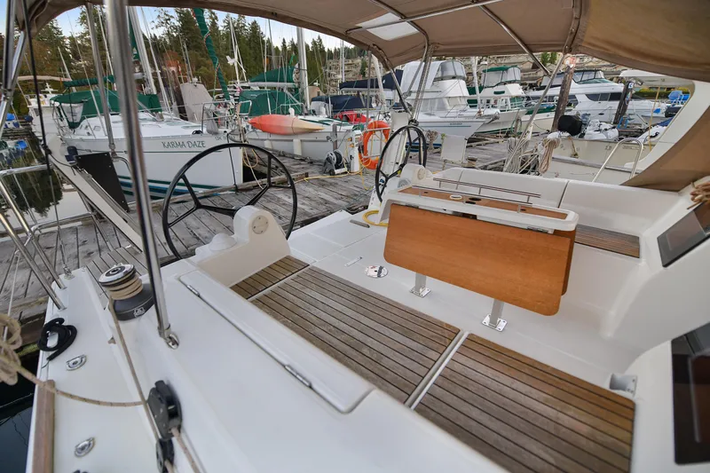 Mayne Deck Yacht Photos Pics 2019 Dufour 382 Grand Large sailboat cockpit with wooden seating and dual steering wheels.
