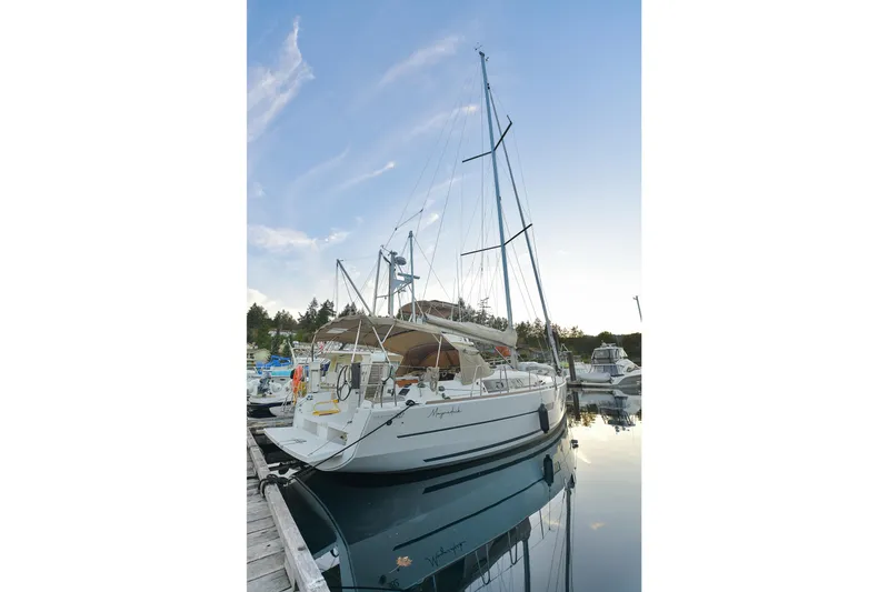 Mayne Deck Yacht Photos Pics 2019 Dufour 382 Grand Large sailboat docked at marina, calm water reflection.
