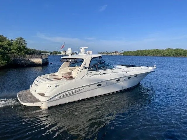  Yacht Photos Pics 2002 Sea Ray 460 Sundancer on calm water under clear skies.