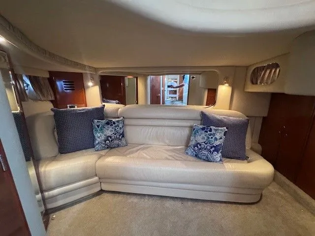  Yacht Photos Pics Interior of a 2002 Sea Ray 460 Sundancer yacht with beige sofa and cushions.