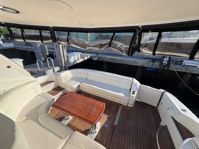  Yacht Photos Pics Interior of a 2002 Sea Ray 460 Sundancer yacht with wooden table.