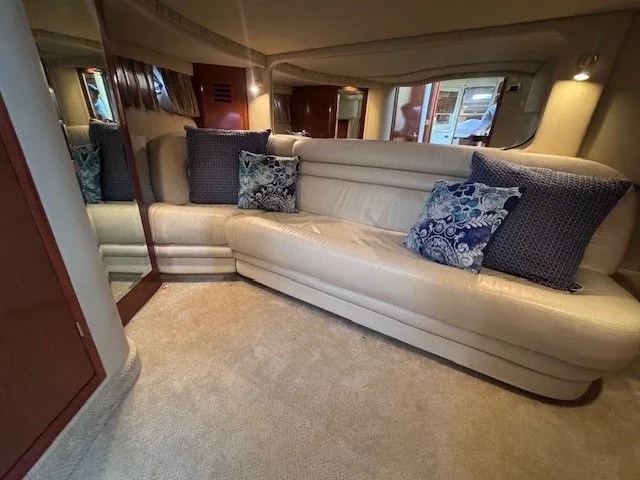  Yacht Photos Pics Interior of 2002 Sea Ray 460 Sundancer with beige sofa and blue pillows.