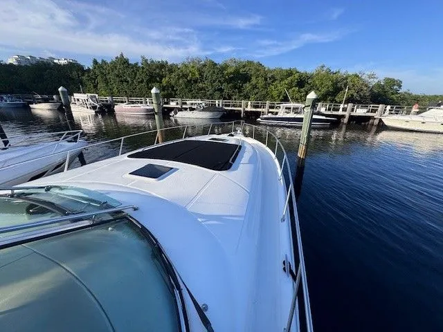  Yacht Photos Pics Sea Ray 460 Sundancer 2002 docked in a serene marina.