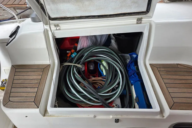  Yacht Photos Pics Open storage compartment on 2010 Hanse 400e yacht with coiled hose and tools.