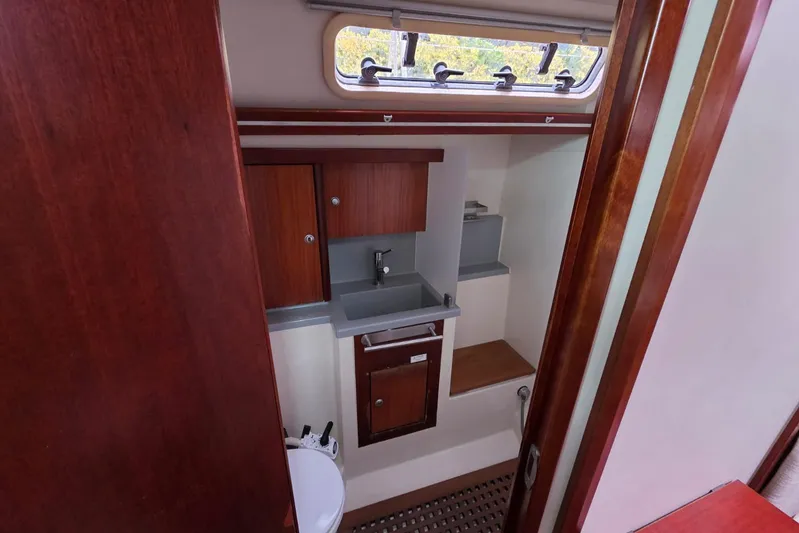  Yacht Photos Pics 2010 Hanse 400e yacht bathroom with wooden cabinetry and compact sink.