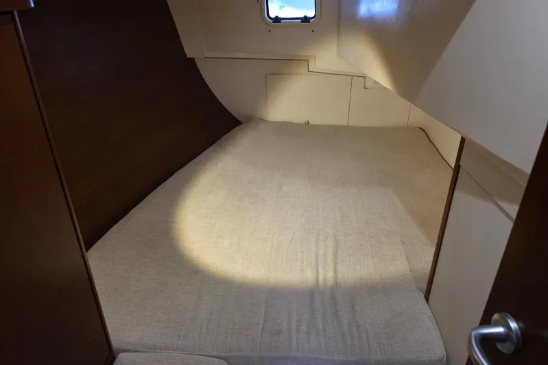  Yacht Photos Pics 2010 Hanse 400e yacht cabin with beige bedding and wooden accents.