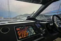 Interior view of 2014 Princess V48 Open yacht cockpit with navigation display.