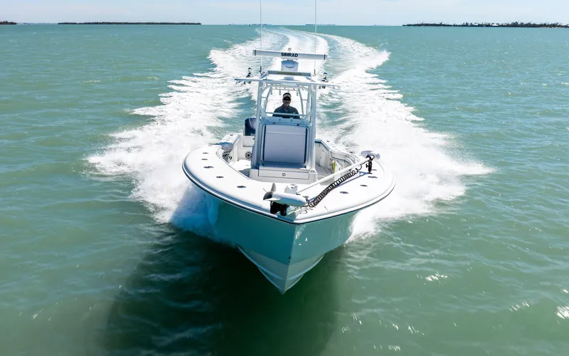  Yacht Photos Pics 2019 Yellowfin 36 boat cruising on open water, creating a dynamic wake.