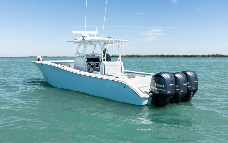  Yacht Photos Pics 2019 Yellowfin 36 boat with triple Yamaha engines on calm water.