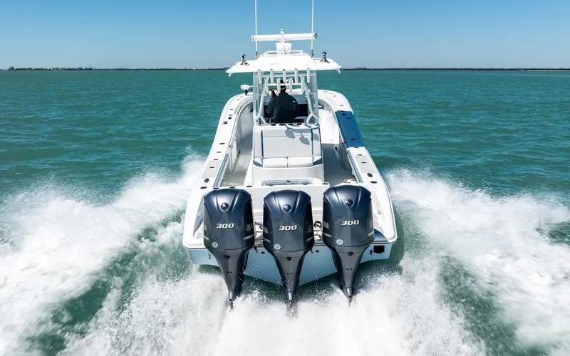  Yacht Photos Pics 2019 Yellowfin 36 boat with triple 300 horsepower engines cruising on open water.
