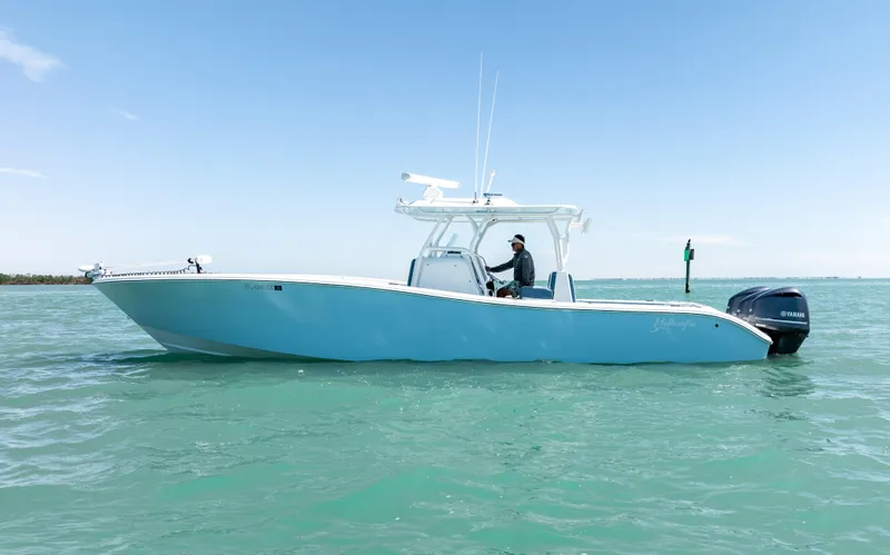  Yacht Photos Pics 2019 Yellowfin 36 boat on calm turquoise water under clear blue sky.