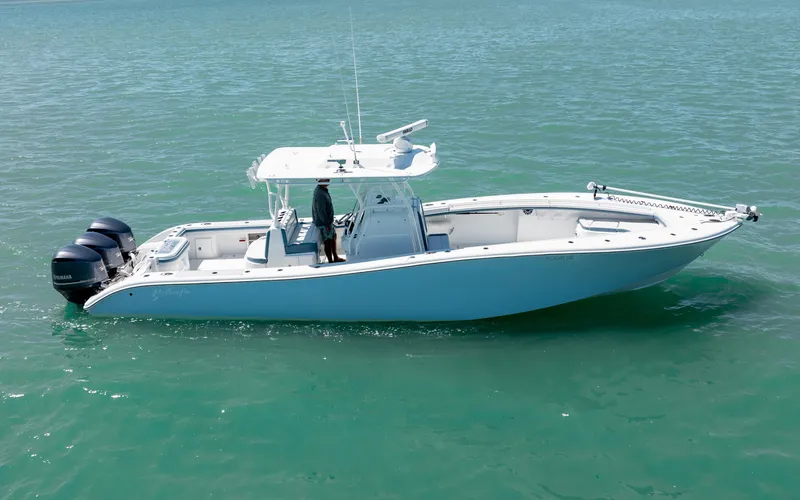  Yacht Photos Pics 2019 Yellowfin 36 boat on calm turquoise water, featuring dual outboard motors.