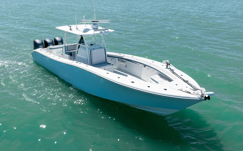  Yacht Photos Pics 2019 Yellowfin 36 boat on open water, featuring triple outboard engines.
