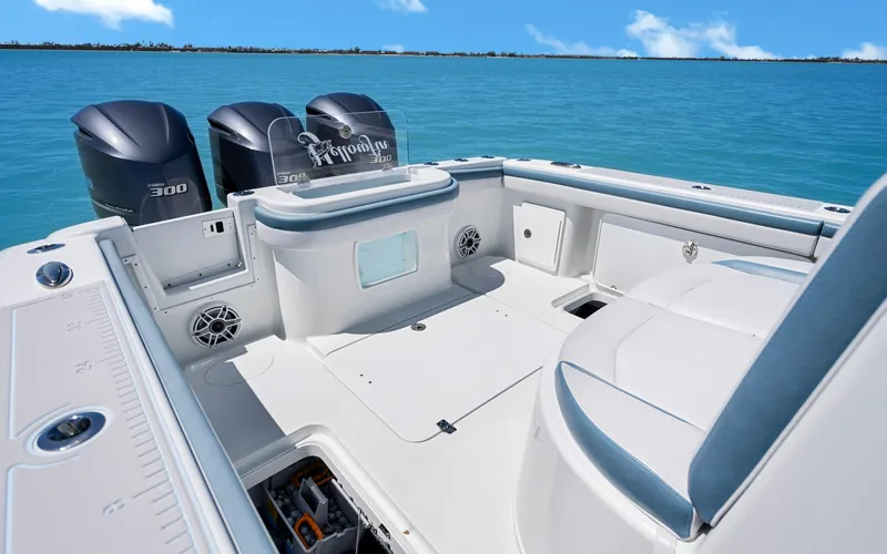  Yacht Photos Pics 2019 Yellowfin 36 boat with triple outboard engines on clear blue water.