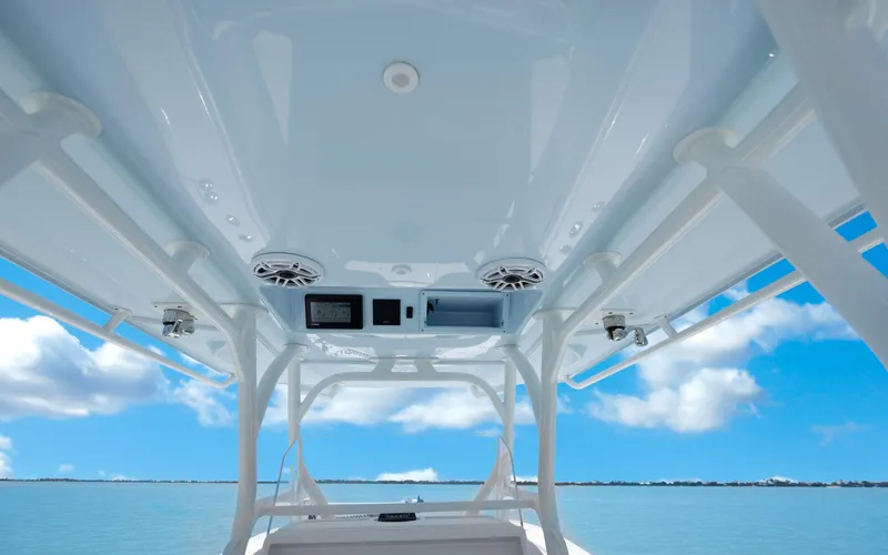  Yacht Photos Pics 2019 Yellowfin 36 boat interior with speakers and electronics, under a clear blue sky.