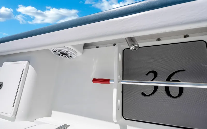  Yacht Photos Pics 2019 Yellowfin 36 boat interior with speaker and storage compartment under blue sky.