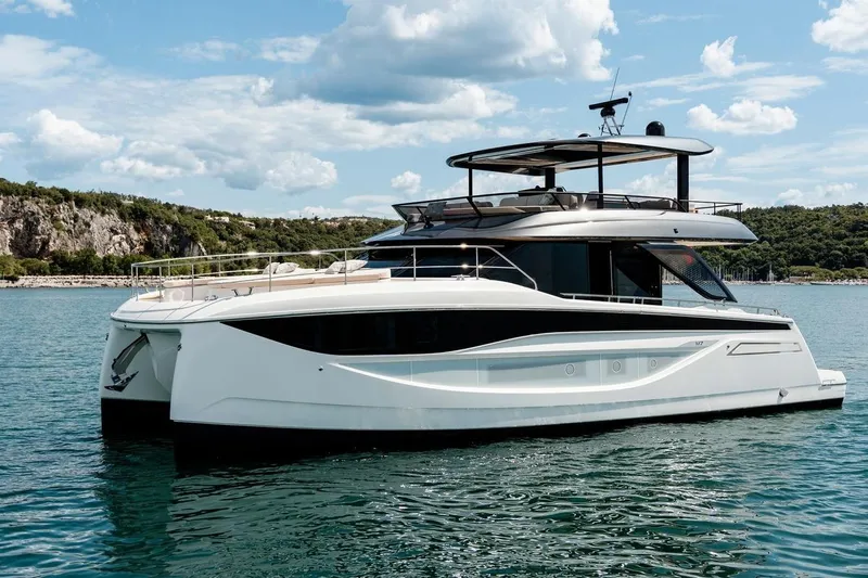 M7 Yacht Photos Pics Luxurious 2026 Prestige yacht on serene water, showcasing sleek design and modern features.