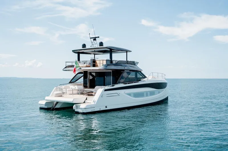 M7 Yacht Photos Pics Luxurious 2026 Prestige yacht on calm blue sea under clear sky.