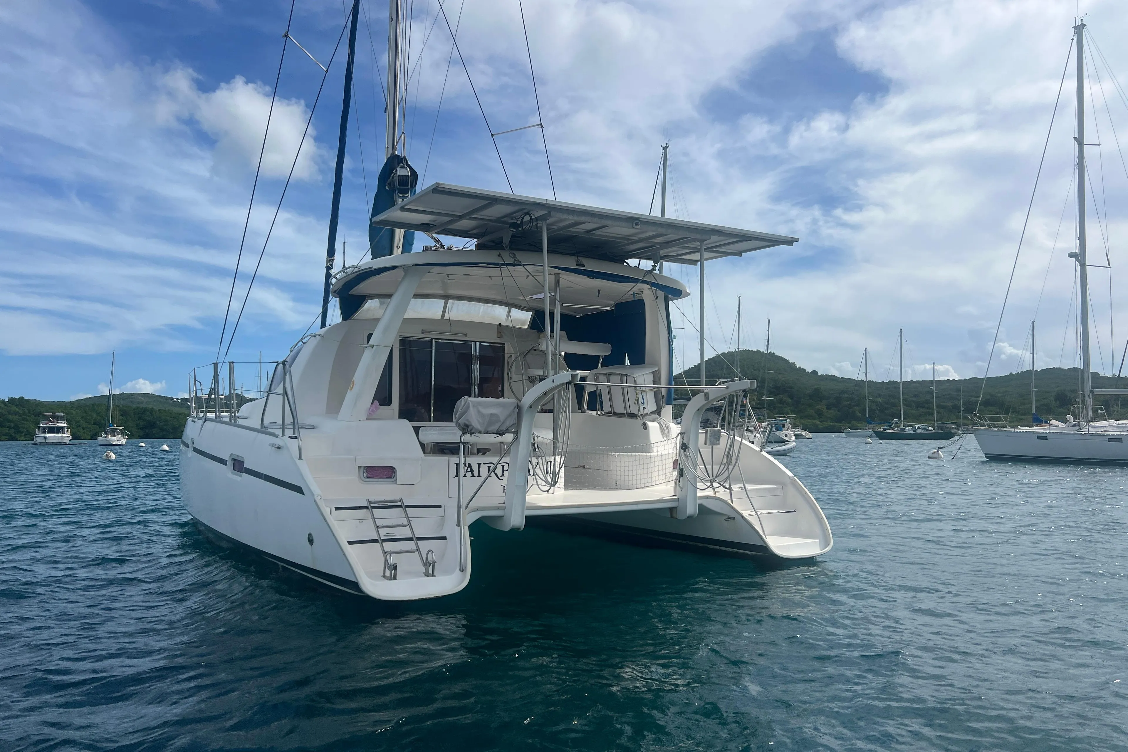 2005 Leopard 40 catamaran anchored in scenic bay with clear skies.