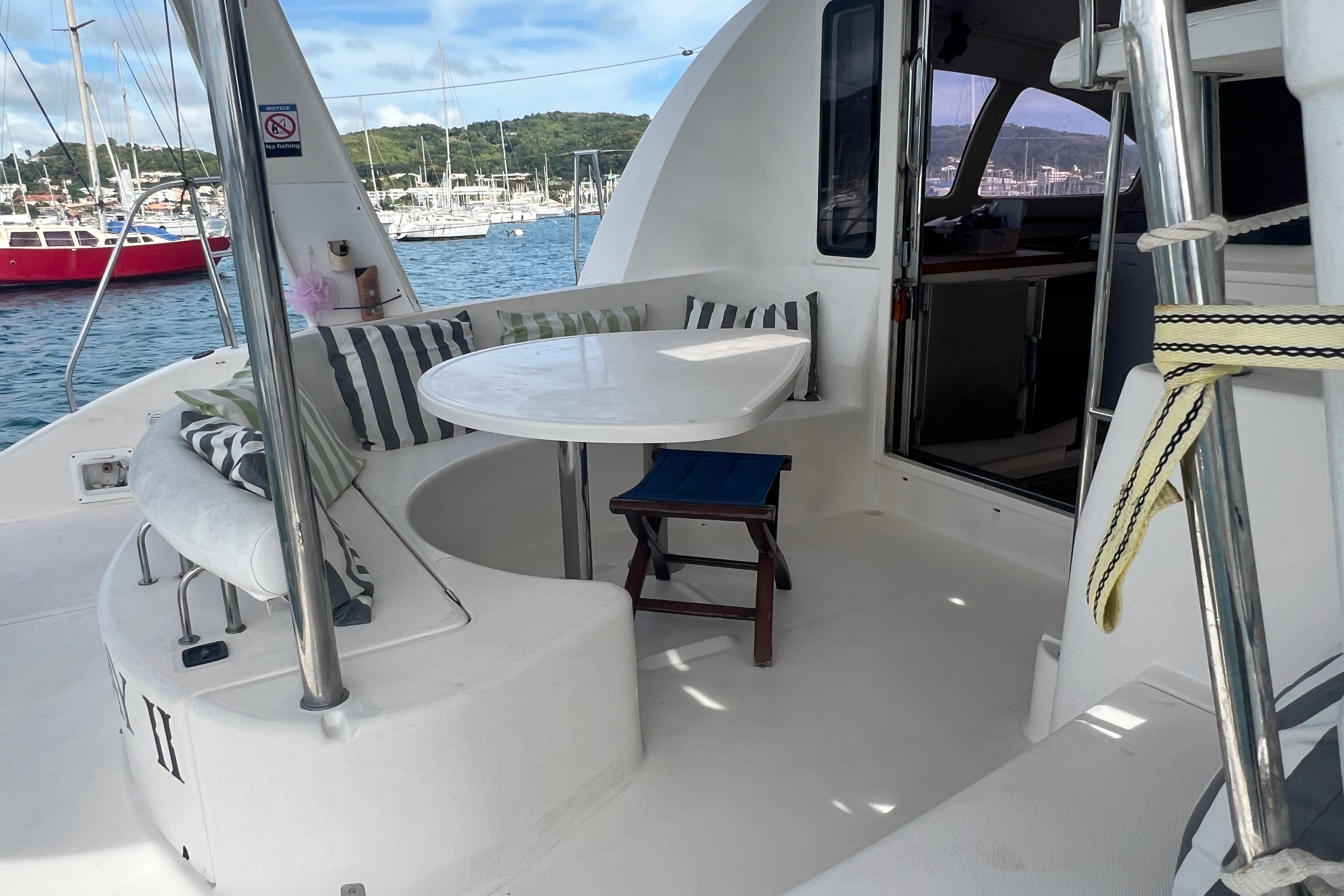 2005 Leopard 40 yacht deck with seating, table, and scenic marina view.