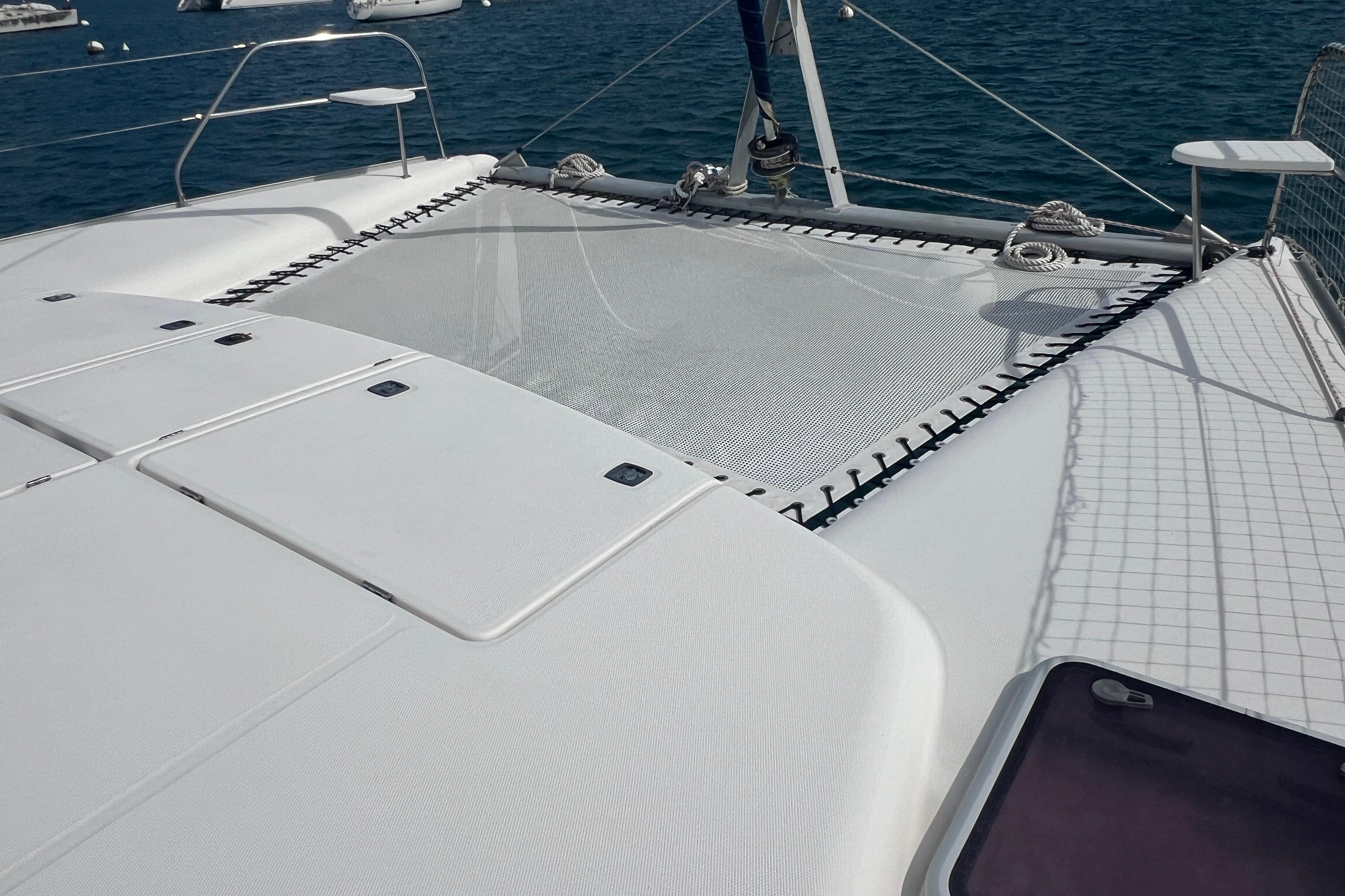 2005 Leopard 40 catamaran deck with netting, anchored in calm blue waters.