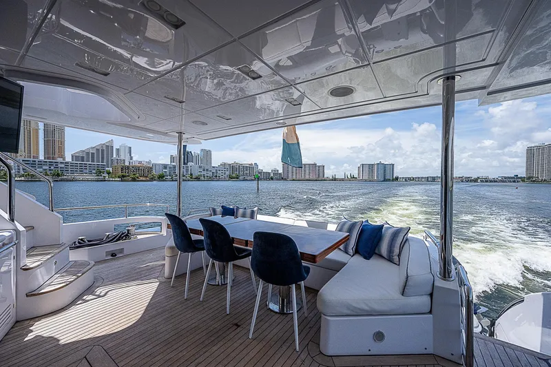 Reset Yacht Photos Pics Luxurious 2011 Azimut 82 yacht deck with seating, city skyline view.