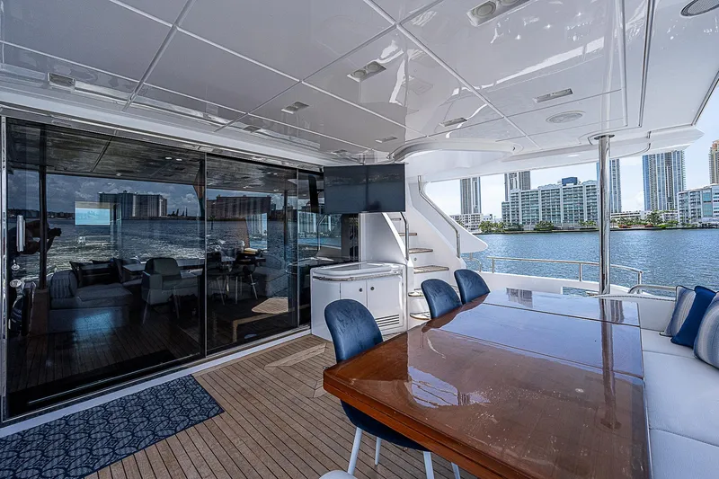 Reset Yacht Photos Pics Luxurious 2011 Azimut 82 yacht deck with dining area, city skyline view.