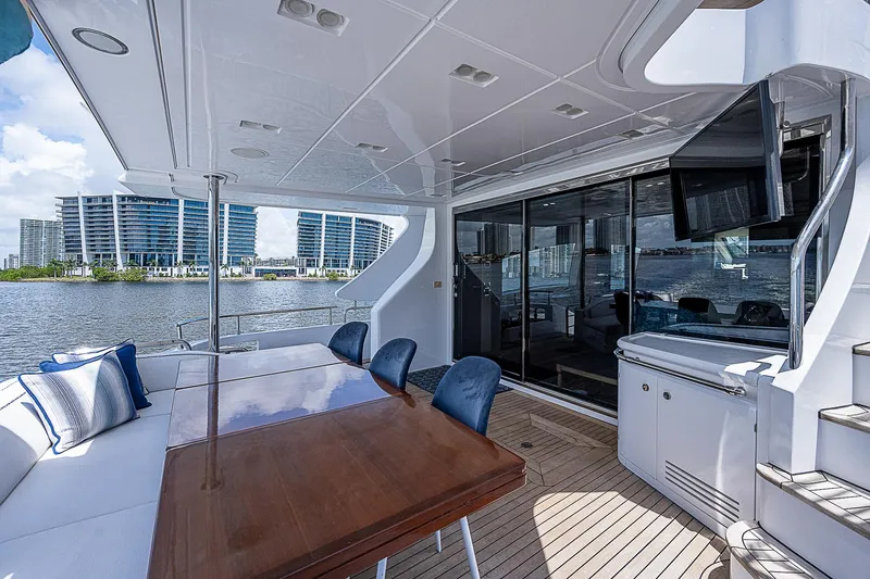Reset Yacht Photos Pics Luxurious 2011 Azimut 82 yacht deck with dining area and waterfront view.