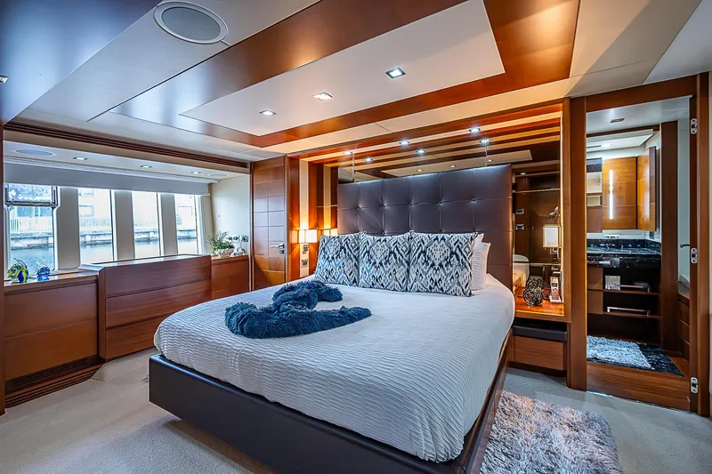 Reset Yacht Photos Pics Luxurious bedroom interior of 2011 Azimut 82 yacht with modern design and large windows.