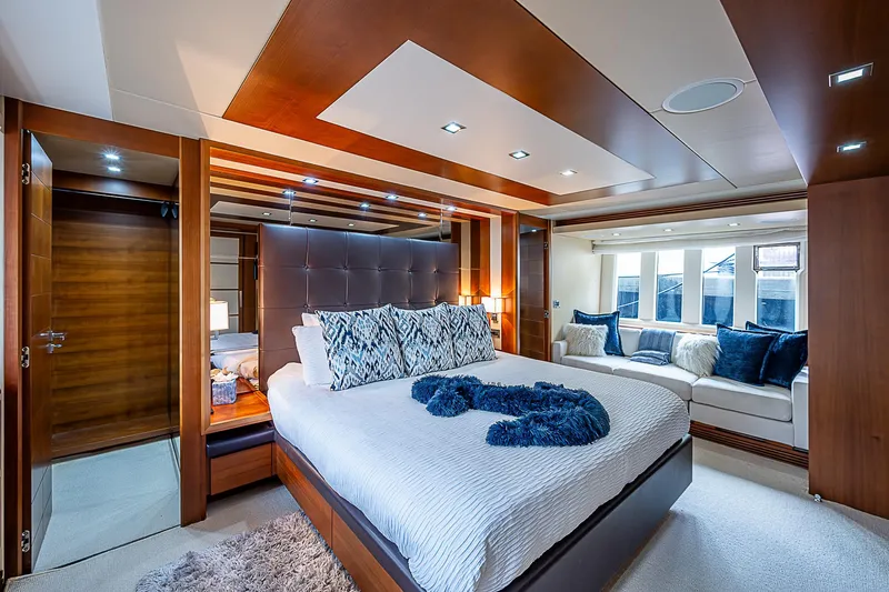 Reset Yacht Photos Pics Luxurious bedroom interior of 2011 Azimut 82 yacht with modern design and plush furnishings.