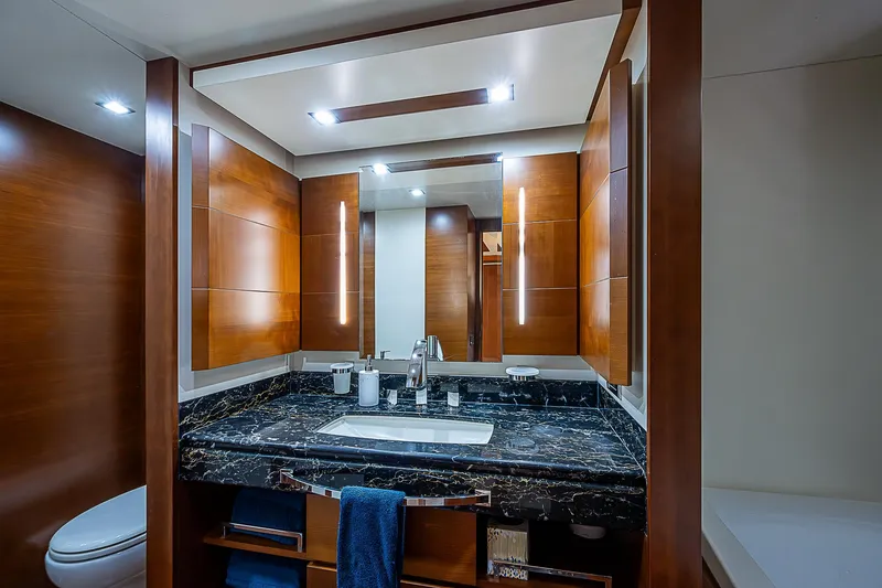 Reset Yacht Photos Pics Luxurious bathroom in 2011 Azimut 82 yacht with modern fixtures and wood accents.