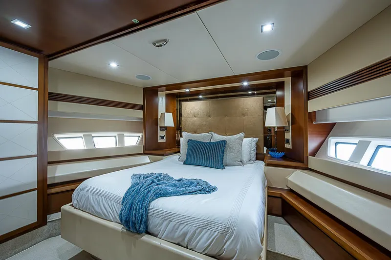 Reset Yacht Photos Pics Luxurious bedroom interior of 2011 Azimut 82 yacht with elegant decor and ambient lighting.
