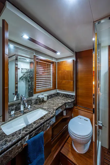 Reset Yacht Photos Pics Luxurious bathroom in 2011 Azimut 82 yacht with marble countertop and wooden accents.