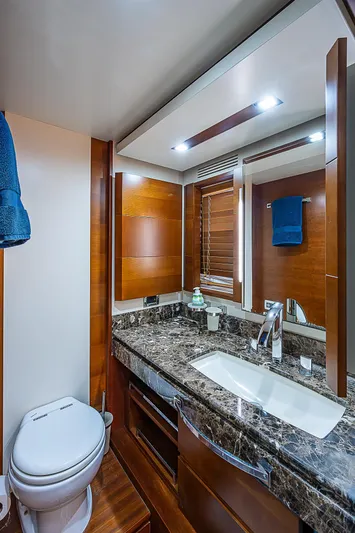 Reset Yacht Photos Pics Luxurious bathroom in 2011 Azimut 82 yacht with marble countertop and modern fixtures.