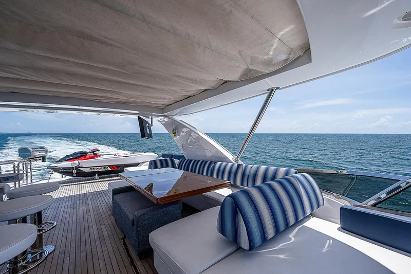 Reset Yacht Photos Pics Luxurious 2011 Azimut 82 yacht deck with striped seating, ocean view, and jet ski.