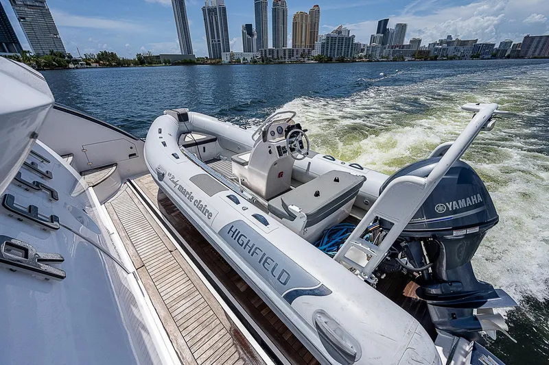 Reset Yacht Photos Pics Azimut 82 yacht with Highfield tender and Yamaha engine, city skyline in background.