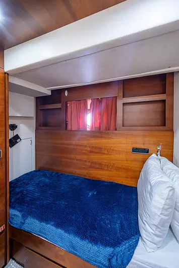 Reset Yacht Photos Pics Cozy cabin interior of 2011 Azimut 82 yacht with blue bedding and wooden accents.