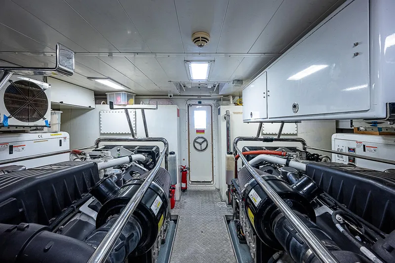 Reset Yacht Photos Pics Engine room of a 2011 Azimut 82 yacht, featuring dual engines and storage cabinets.