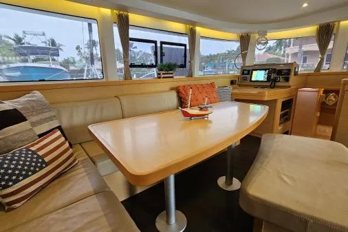 Never Say Never Yacht Photos Pics Interior of 2017 Lagoon 42 catamaran with cozy seating and navigation equipment.