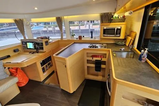 Never Say Never Yacht Photos Pics Modern kitchen interior of 2017 Lagoon 42 catamaran with appliances and navigation equipment.